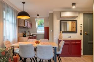 a kitchen and dining room with a table and chairs at Willa Bukowy Las - Everslow in Szklarska Poręba +49 photos