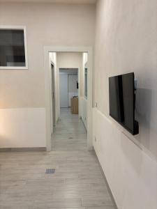 a hallway with a flat screen tv on a wall at Vacanze a 2 passi dal mare in Giardini Naxos +10 photos