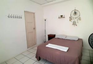 a bedroom with a bed and a clock on the wall at Casa Andrea in Flores +8 photos