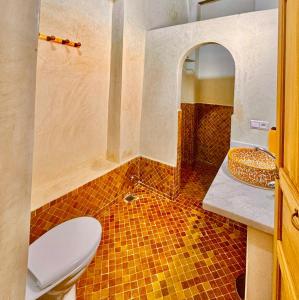 a bathroom with a toilet and a sink at Dar Elinor Fez in Fès +30 photos