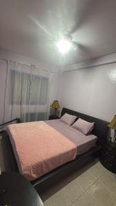 Ένα ή περισσότερα κρεβάτια σε δωμάτιο στο Palm Beach