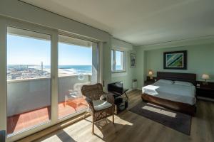 a bedroom with a bed and a view of the ocean at Hotel Apartamento Solverde in Espinho +102 photos