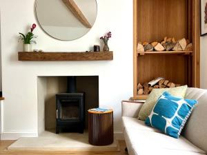 a living room with a couch and a mirror at Mid-Century Gem - Heart of Frome in Frome