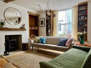 a living room with a couch and a fireplace at Mid-Century Gem - Heart of Frome in Frome +41 photos