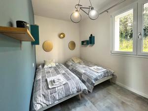 two twin beds in a room with a window at homeliday ACTIVE in Caldana +39 photos
