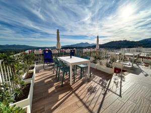 a patio with a table and chairs on a balcony at homeliday ACTIVE in Caldana