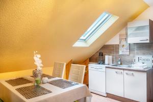 a kitchen with a table and a sink and a window at Fewo Wilhelmshaven Langewerth in Roffhausen +16 photos