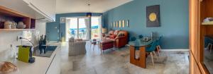 a living room with blue walls and a table at homeliday ACTIVE in Caldana