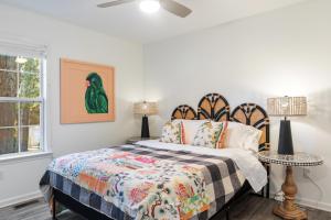 a bedroom with a bed and two tables with lamps at The Clover Cottage in Normaltown in Athens
