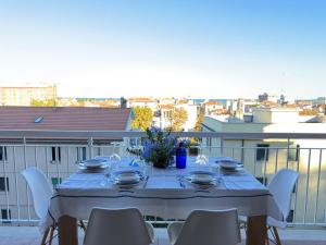 a table on a balcony with a view of a city at Terrazza vista mare-Parcheggio gratuito -3Min A14 -Mastrangelo Beach in Grottammare