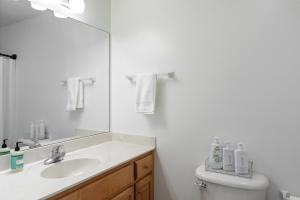 a bathroom with a sink and a toilet and a mirror at The Clover Cottage in Normaltown in Athens +13 photos