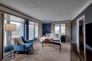 a hotel room with a living room with a couch and a table at Hamilton Hotel - Washington DC in Washington