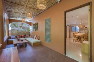 a living room with a couch and a table at Terracotta House in General Luna