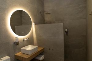 a bathroom with a sink and a mirror at UVA Apartamentos in Badajoz +7 photos