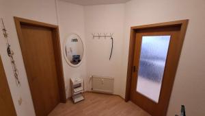an empty hallway with a door and a mirror at Ferienwohnung DEICHBLICK 200m zum Strand Zingst Darß in Zingst