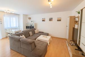 a living room with a couch and a table at Ferienwohnung DEICHBLICK 200m zum Strand Zingst Darß in Zingst +22 photos