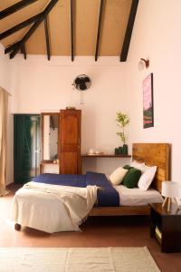 un dormitorio con una cama grande en una habitación en Notu by Raho - Secluded Villa with Estate View, en Siddapur