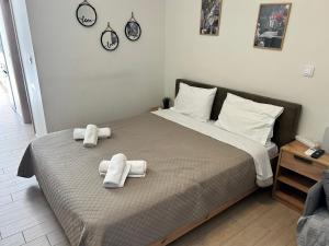 a bedroom with a bed with towels on it at Chris3 in Kalamata