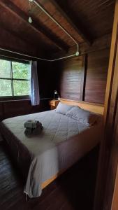 a bedroom with a bed with a camera on it at Bambú Cabaña in El Soberbio