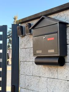 a mail box on the side of a brick wall at Apartamenty Gliwicka 12  +35 photos