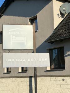 a sign in front of a building at Apartamenty Gliwicka 12 