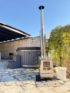 a stone patio with an outdoor stove in front of a building at Apartamenty Gliwicka 12 