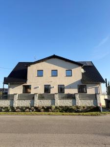 a house with a black roof on the side of a street at Apartamenty Gliwicka 12 