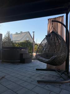 a hammock hanging from awning on a patio at Apartamenty Gliwicka 12 