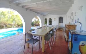 a kitchen and dining room with a table and chairs at Unglaubliche Villa mit Meerblick und Pool in Font de Sa Cala