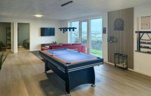a living room with a pool table and a couch at Cozy Home In Haderslev With Wifi in Haderslev +38 photos