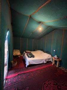 a room with a bed in a tent at Desert tours&trips in Zagora