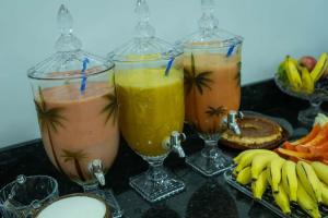 drie drankjes in glazen op een tafel met bananen bij Hotel Ideal 5 in Araguaína +3 foto's