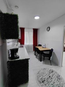 a room with a table and chairs and a dining room at La Monica - Straja - Lupeni - Retezat - Parang in Lupeni