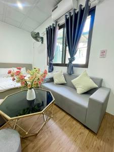 a living room with a couch and a glass table at Hotel Diamond in Hanoi