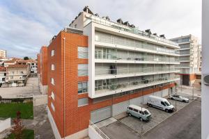 a building with a van parked in front of it at Coral Beach Oasis in Figueira da Foz