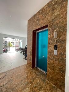 a lobby with a blue door in a building at Hotel Diamond in Hanoi
