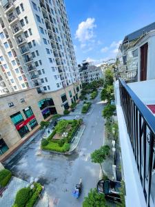 an empty street in a city with tall buildings at Hotel Diamond in Hanoi