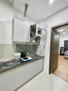 a kitchen with white cabinets and a counter top at Hotel Diamond in Hanoi