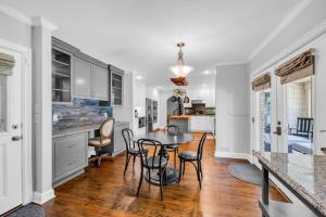 a kitchen with a table and chairs in a room at The Wexford French Chateau w Pool in Athens
