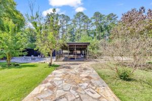 a home with a stone walkway leading to a house at The Wexford French Chateau w Pool in Athens