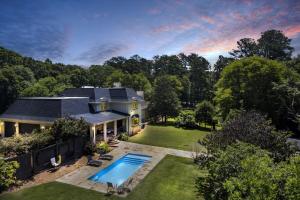 an aerial view of a house with a swimming pool at The Wexford French Chateau w Pool in Athens