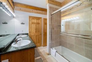a bathroom with a sink and a tub and a shower at Mashie Meadows Log Cabin in Tahoe Vista +17 photos