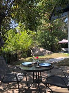 a table and chairs sitting on a patio at Glamping, Piscina, Río y Bosque - Más Líderes Experiencias in Santiago +10 photos