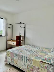 a bedroom with a bed and two mirrors on the wall at Praia e Sol em Caiobá! in Matinhos