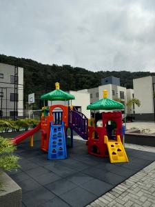 a childrens playground with a slide and a play set at Praia e Sol em Caiobá! in Matinhos