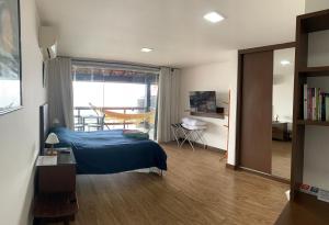 a bedroom with a blue bed and a window at Casa Indaiá in Petrópolis +90 photos