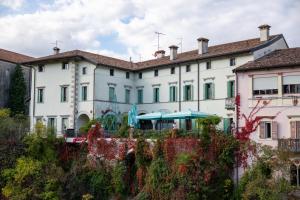 a large white building with a garden in front of it at 1448 Antica Dimora Al Merlo Bianco in Cividale del Friuli