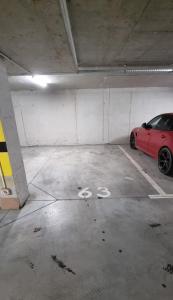a red car parked in a parking garage at Apartament Skarbowa Solis in Leszno