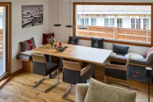 a dining room with a wooden table and chairs at Bergnest 4 in Bivio
