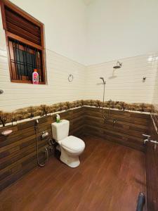 a bathroom with a toilet and a shower at The Pearl Heaven in Dickwella